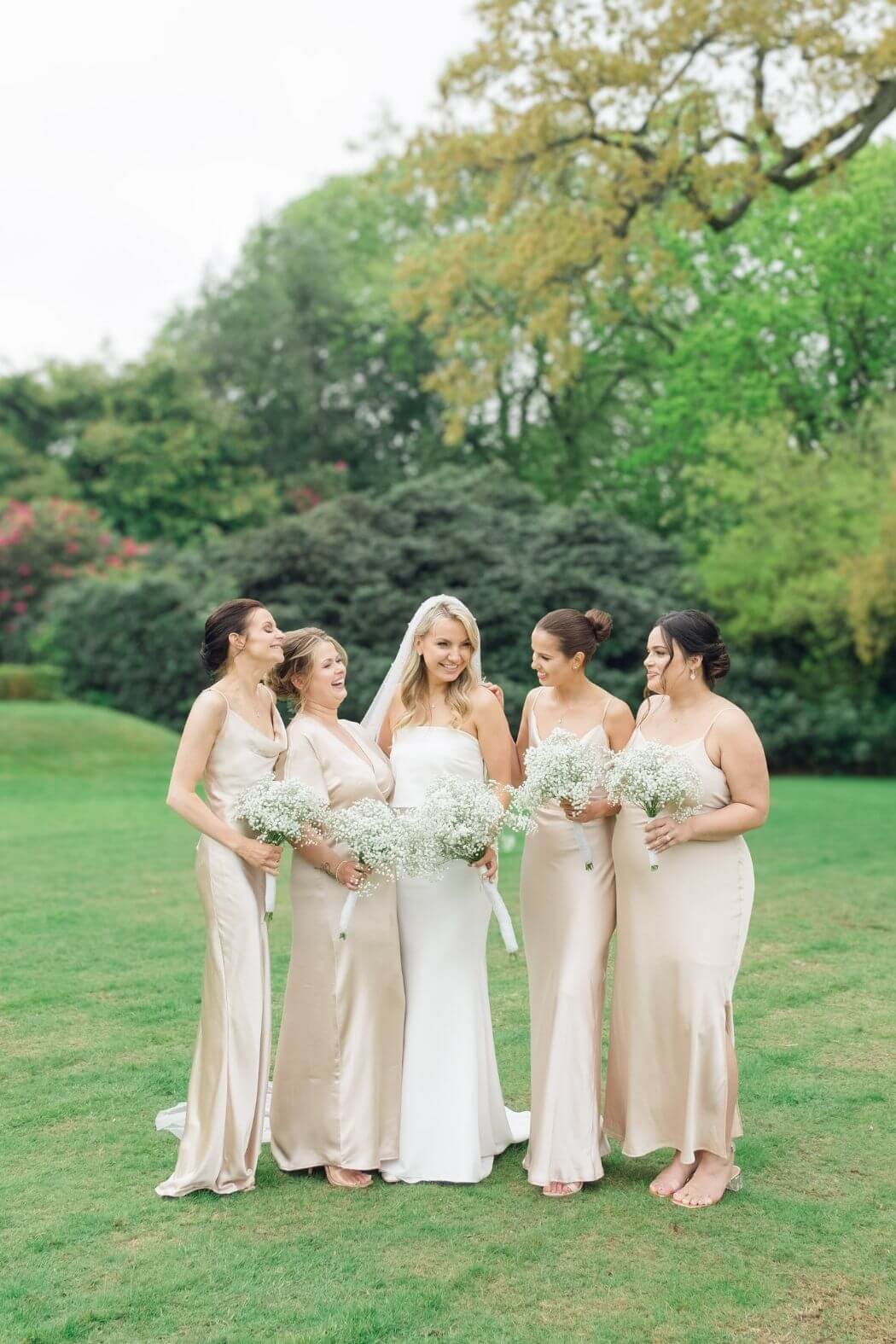 Bride and bridesmaids posed group photograph