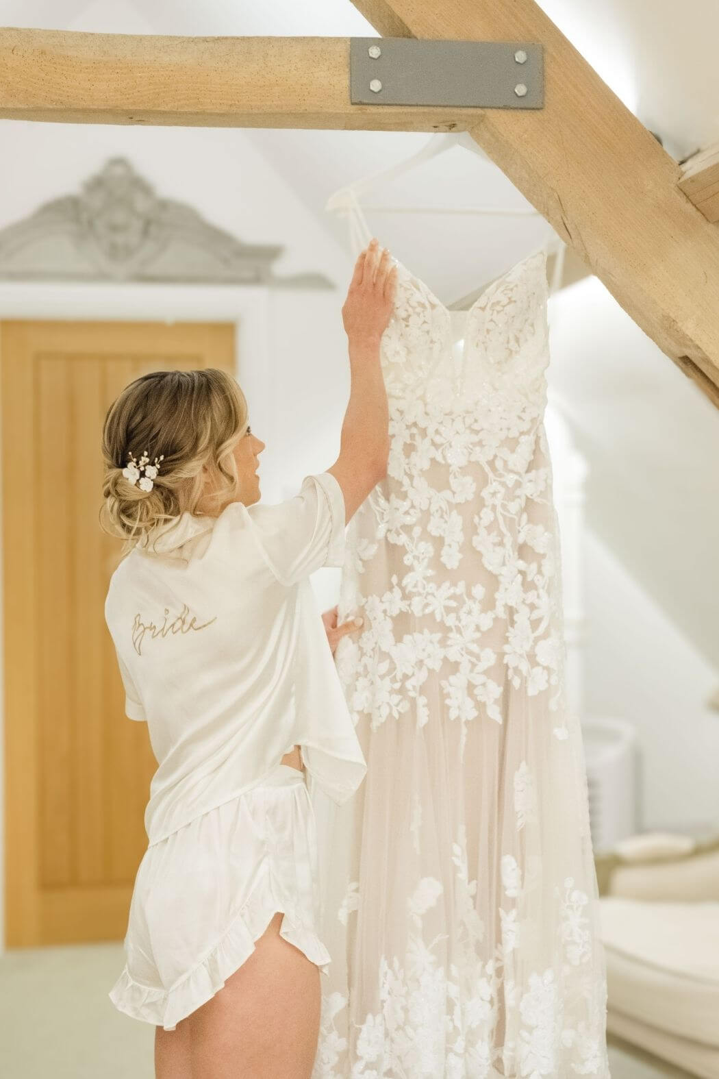 Wedding dress hanging up on the morning of the wedding day