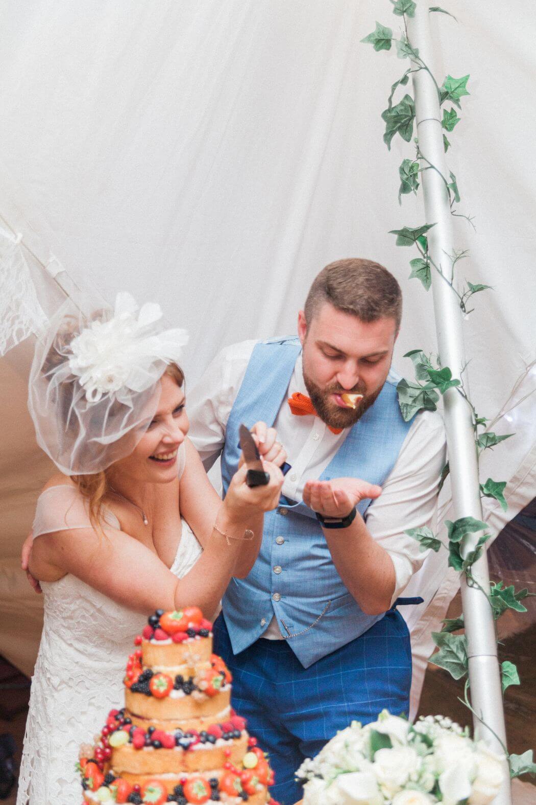 The couple laughing during the cake cutting