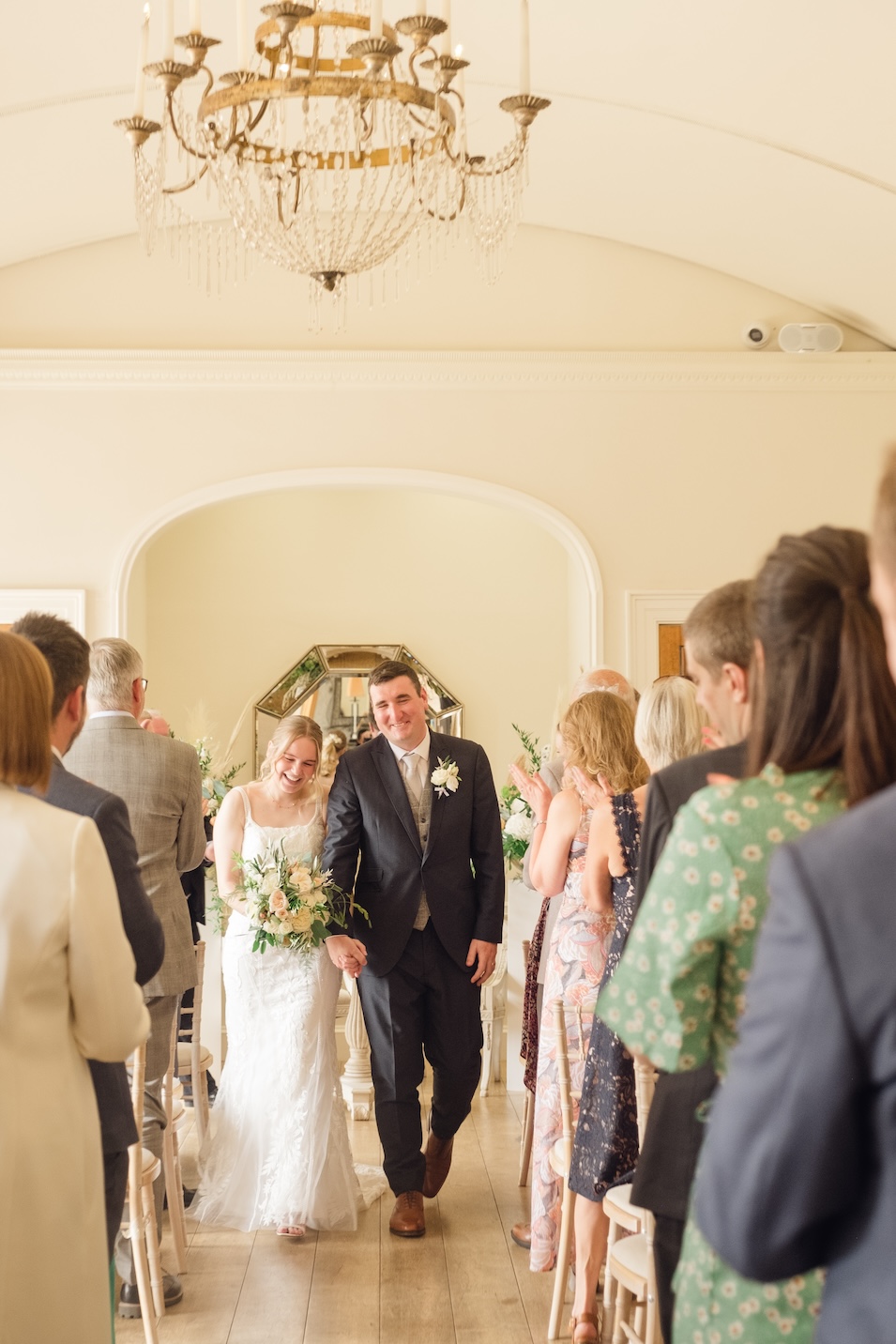 Newlyweds leading guests into the courtyard at Alrewas Hayes