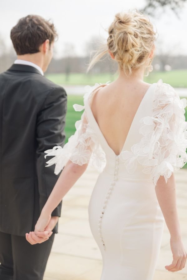 Groom checking his cuffs at a black tie wedding