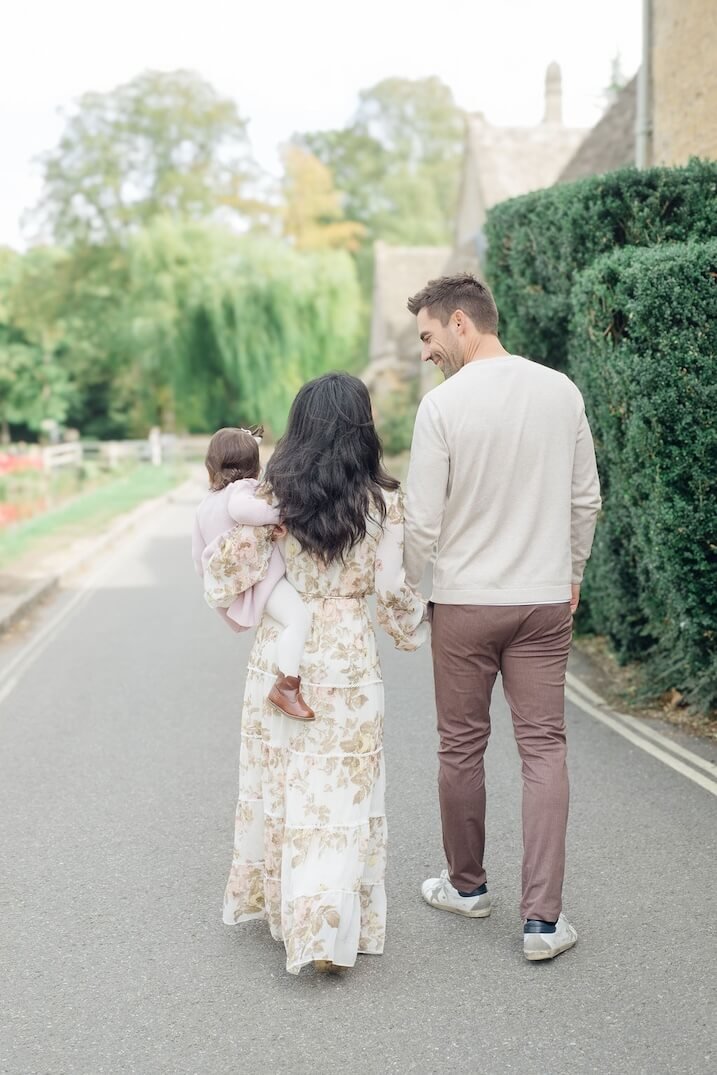 Parents and child walking together during a family photoshoot