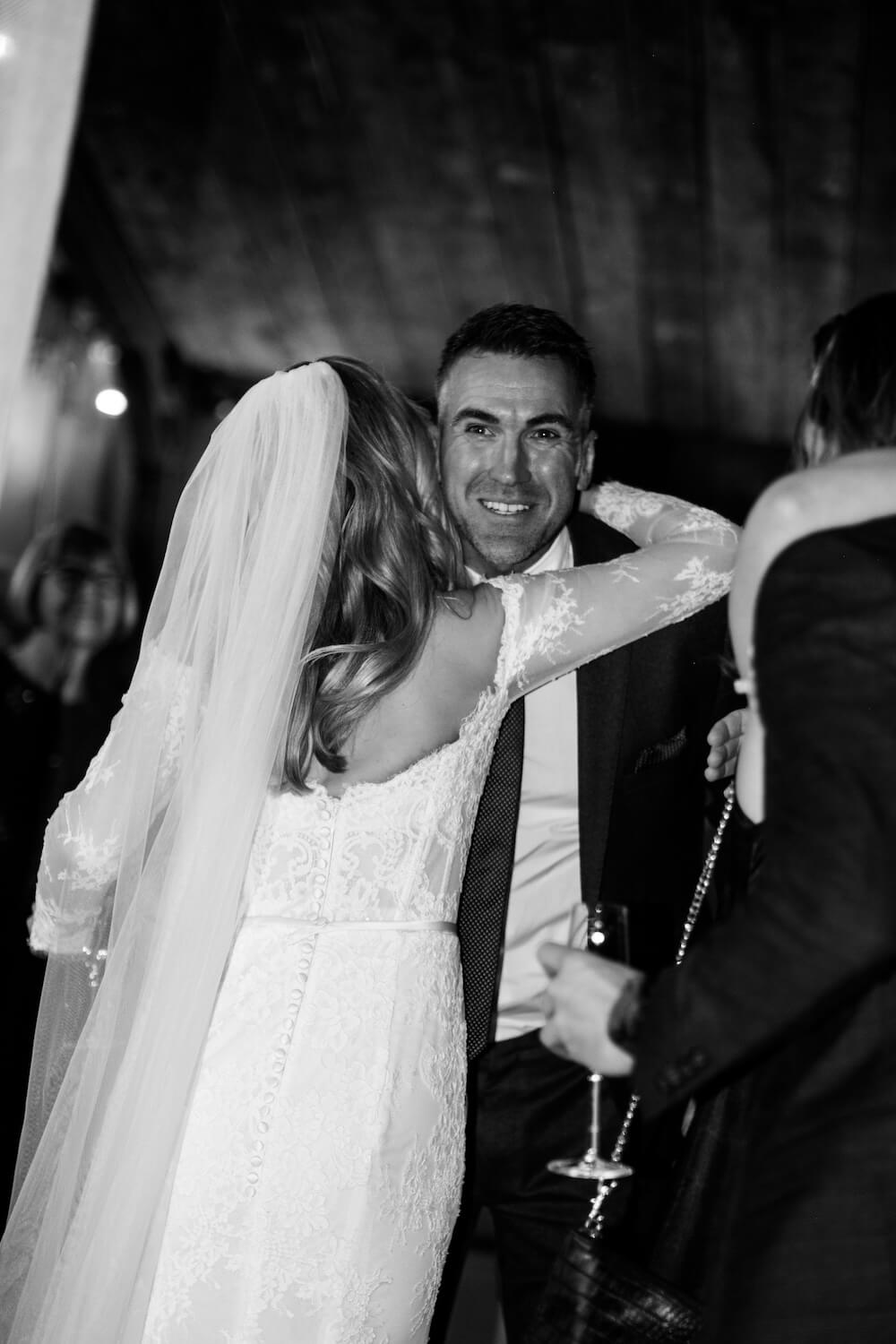 Bride hugging a guest at Grange Wedding Barn Cheshire