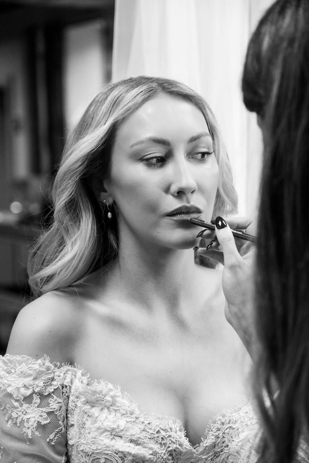 Bride applying lipstick at Grange Wedding Barn Cheshire