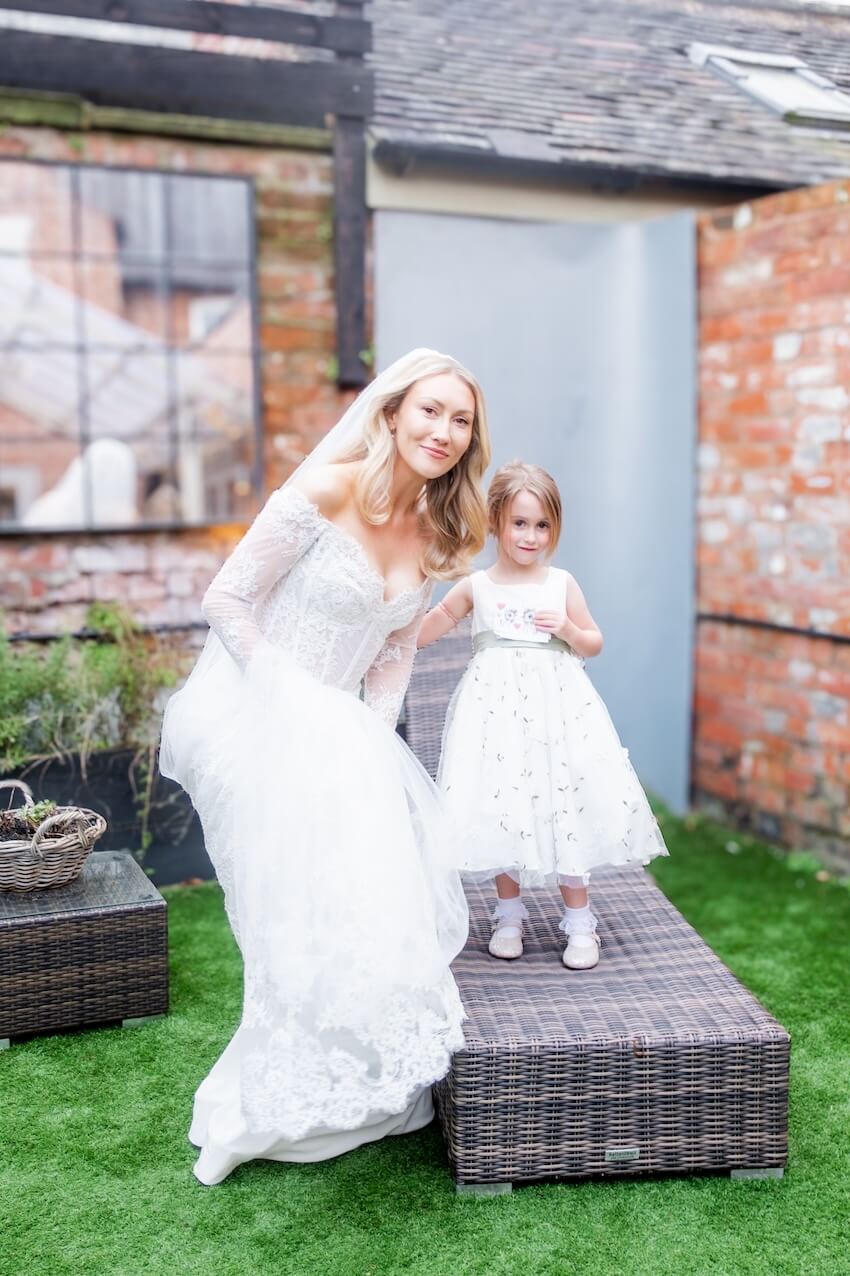Bride with a young flower girl at Grange Wedding Barn Cheshire