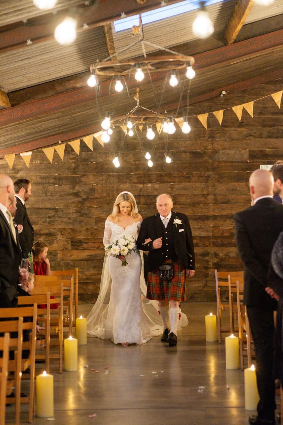 Bride walking down the aisle with her dad at Grange Wedding Barn Cheshire