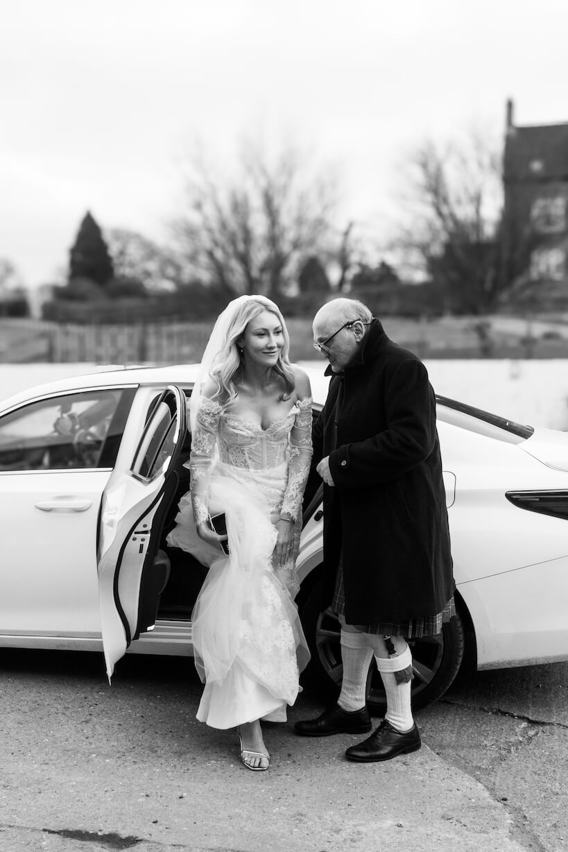 Bride arriving by car at Grange Wedding Barn Cheshire