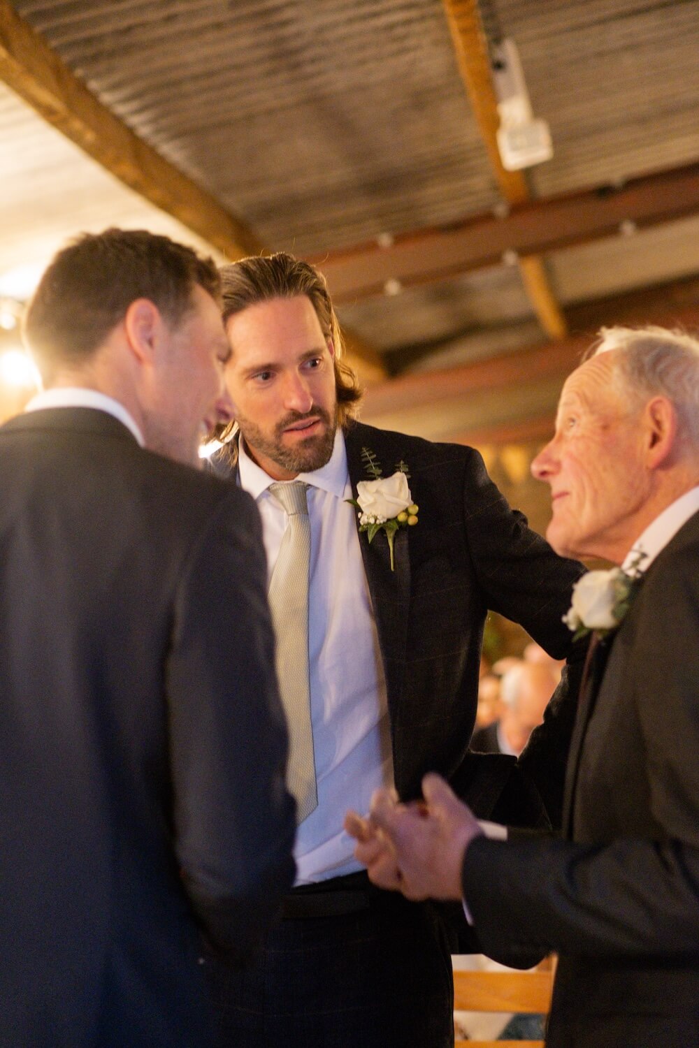 Groom greeting guests at Grange Wedding Barn Cheshire