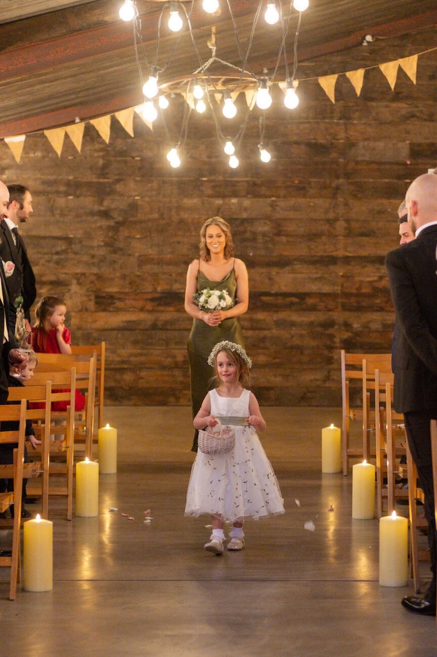 Petal girl walking down the aisle at Grange Wedding Barn Cheshire