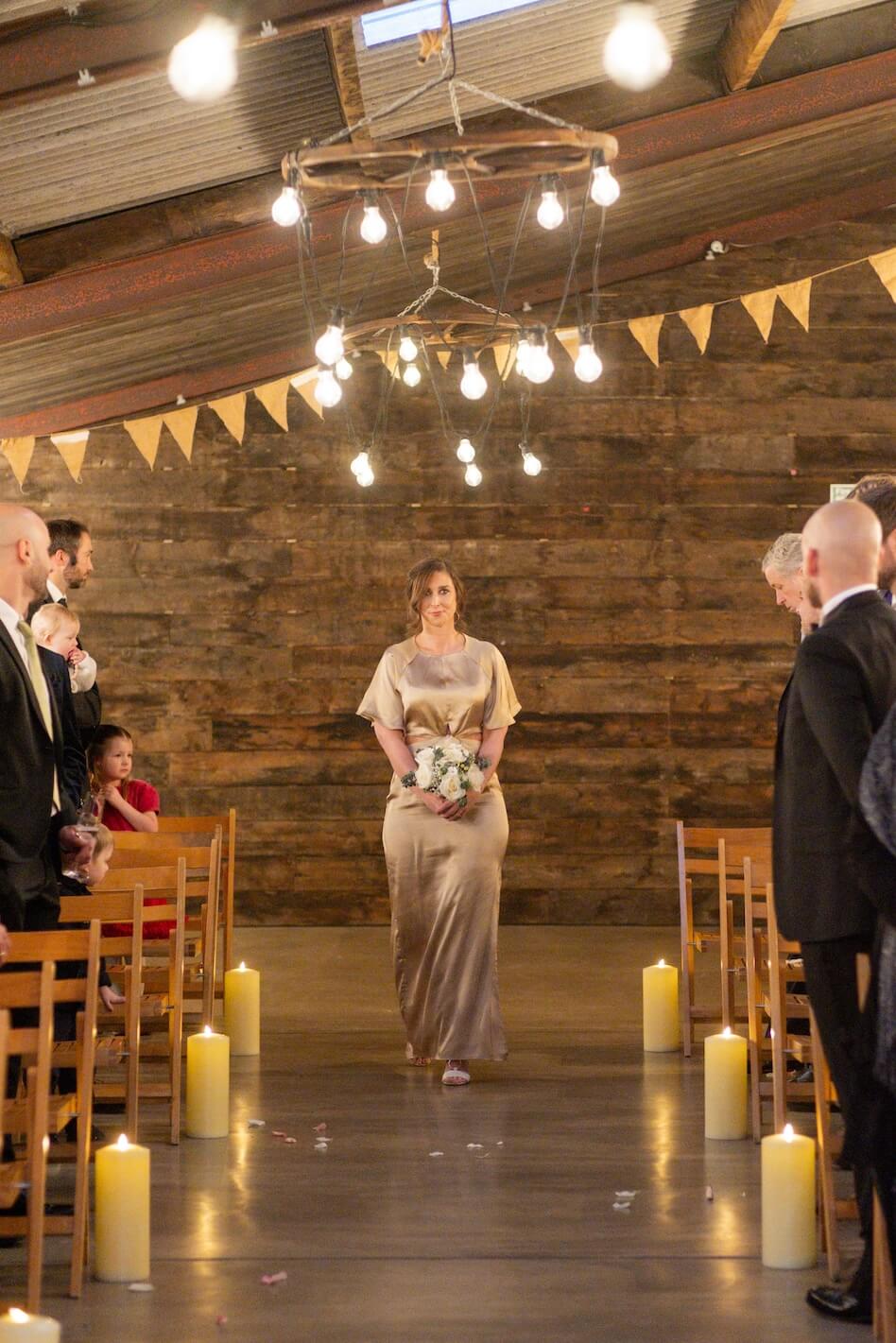 Bridesmaid walking down the aisle at Grange Wedding Barn Cheshire
