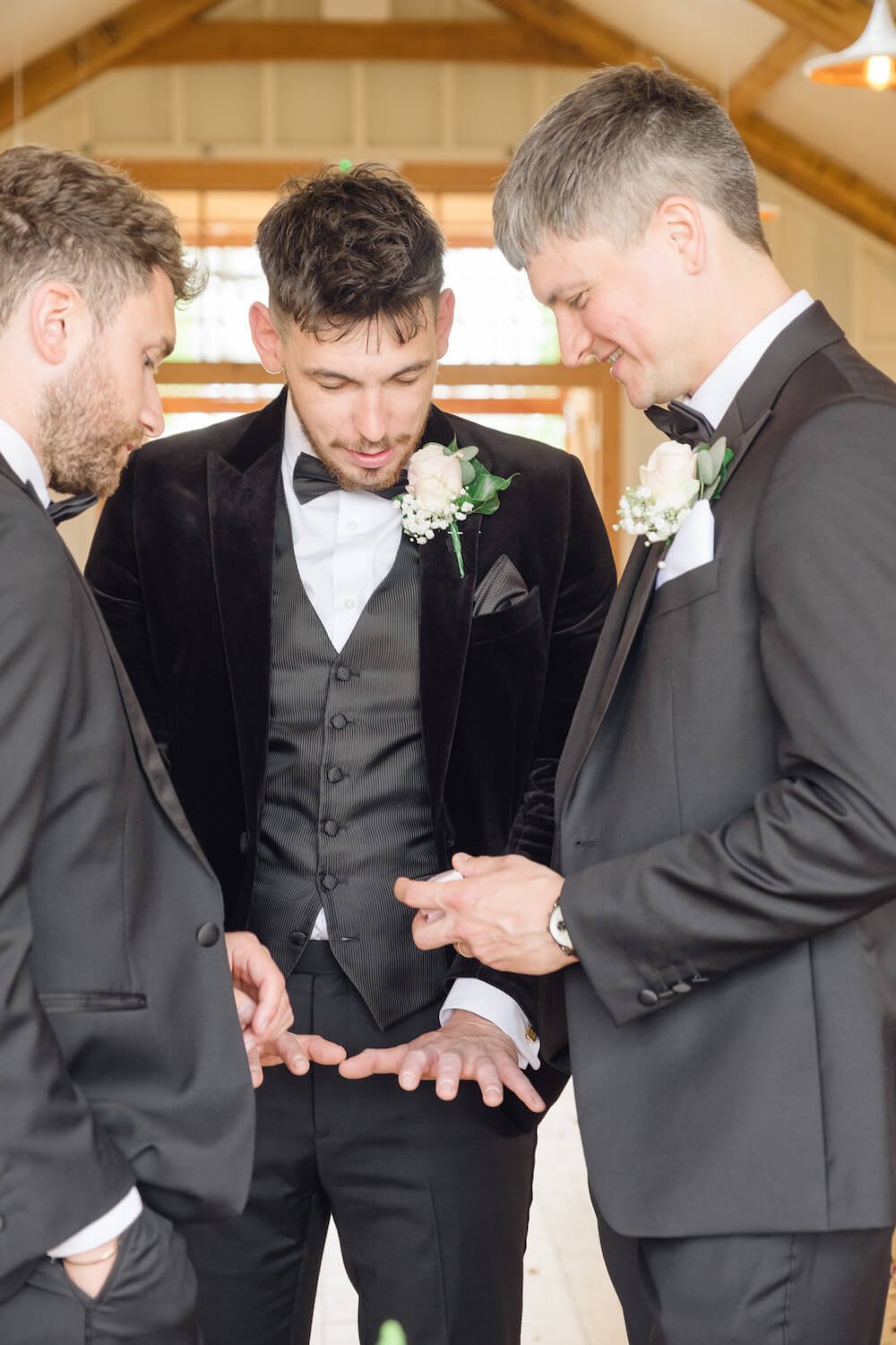 Groom's nervous hands with his groomsmen before the ceremony