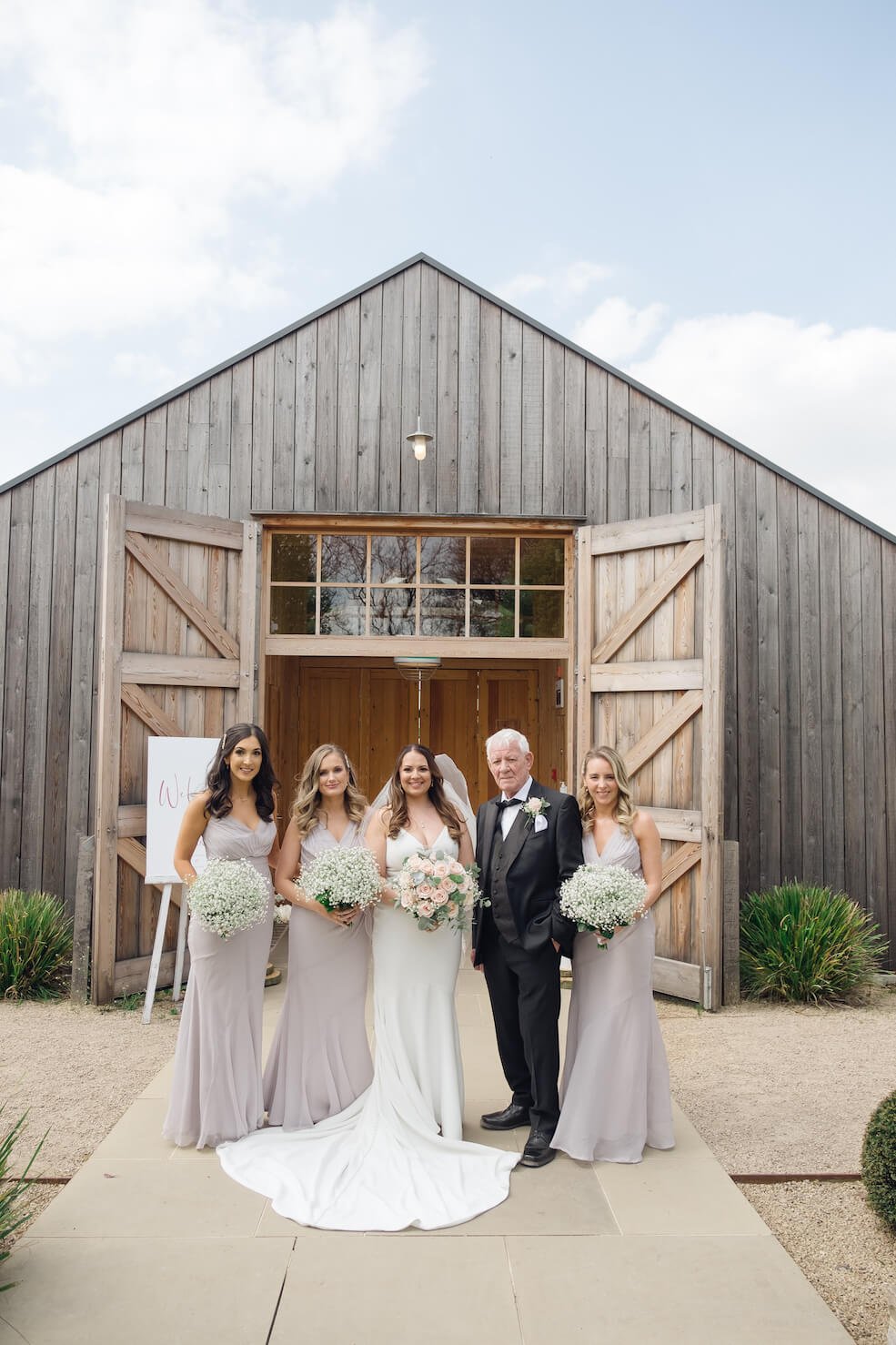 Bride with her father and bridal team in front of the ceremony venue at Hyde House