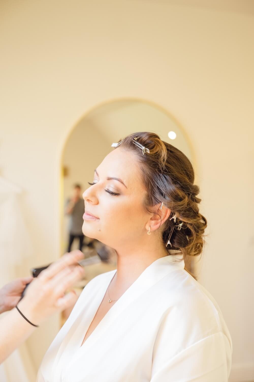 Bride's makeup being finished before her Cotswold wedding
