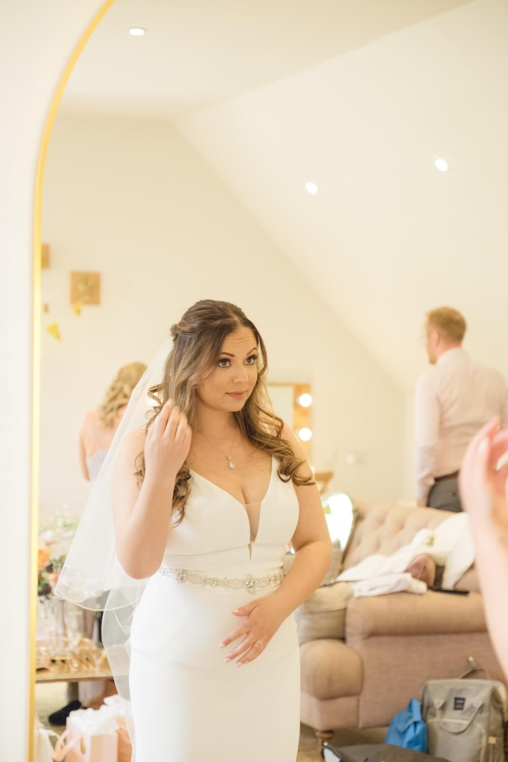 Bride looking in the mirror once she is ready at Hyde House