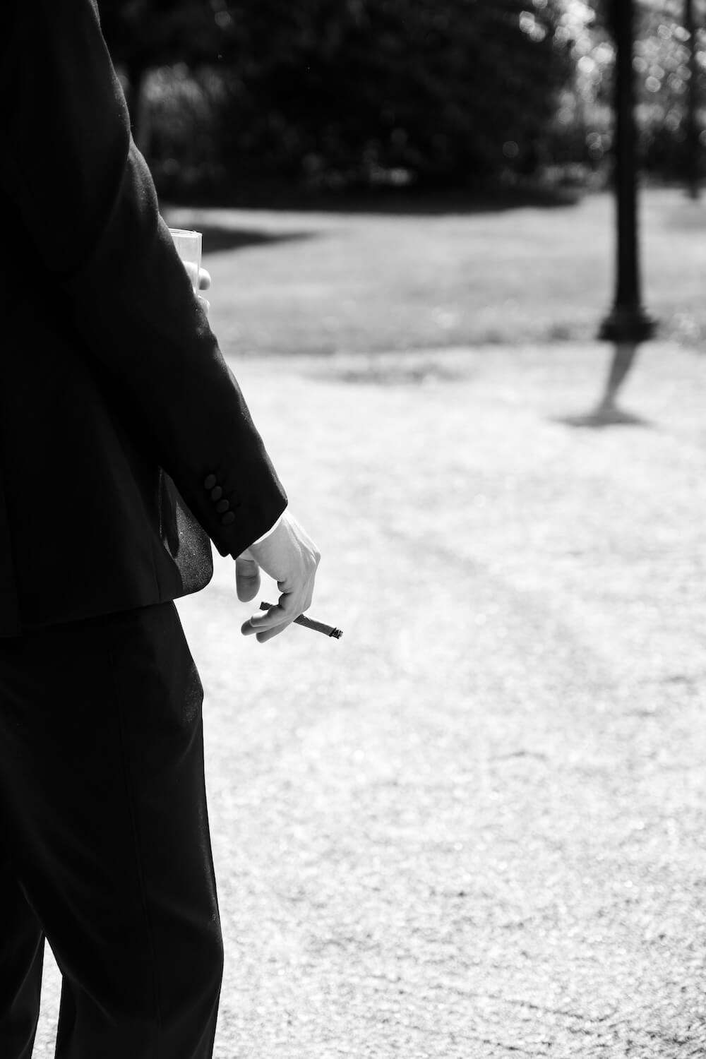 Groom enjoying a cigar on the wedding morning at Hyde House