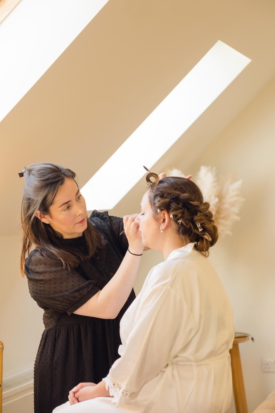 Bride having makeup applied in the bridal suite at Hyde House