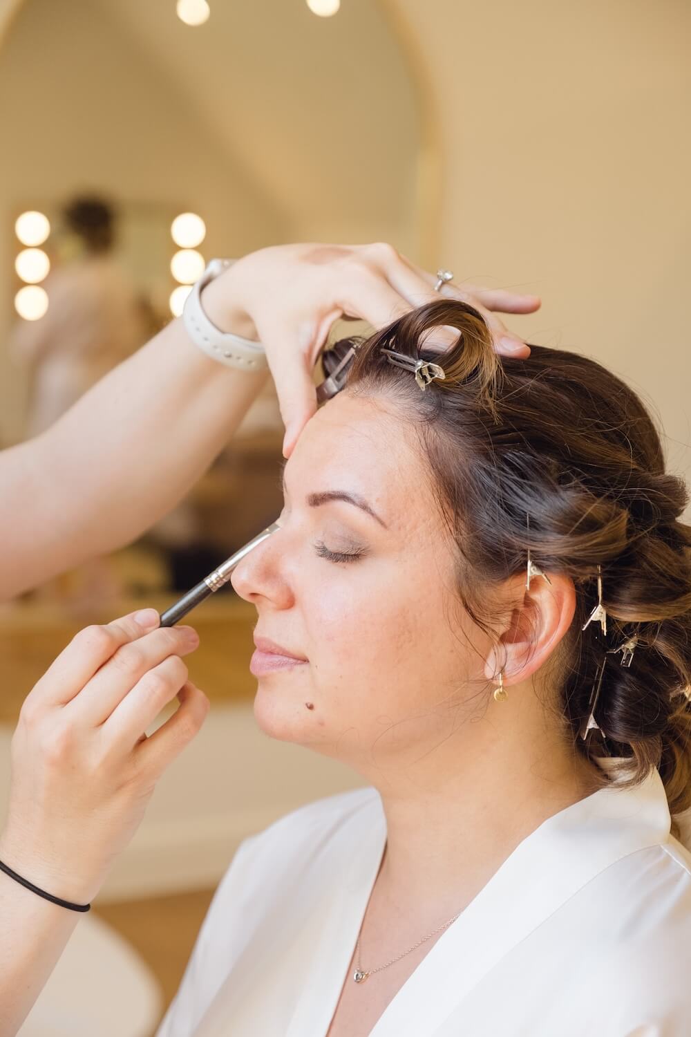 Bride having finishing touches to her makeup at Hyde House