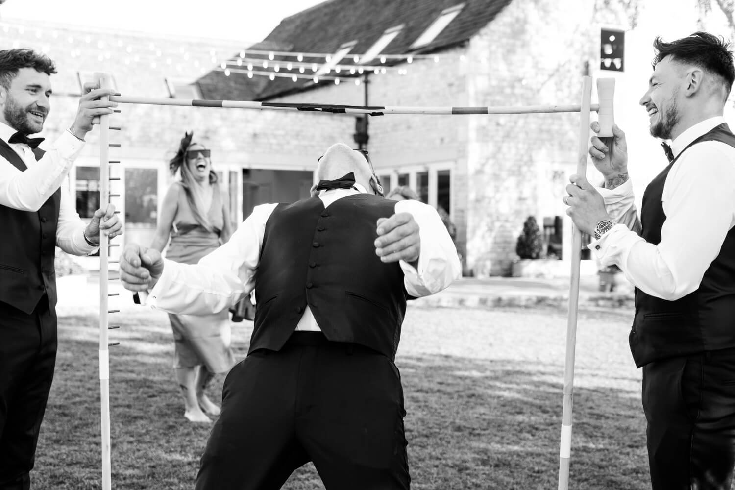 Best man playing limbo at Hyde House