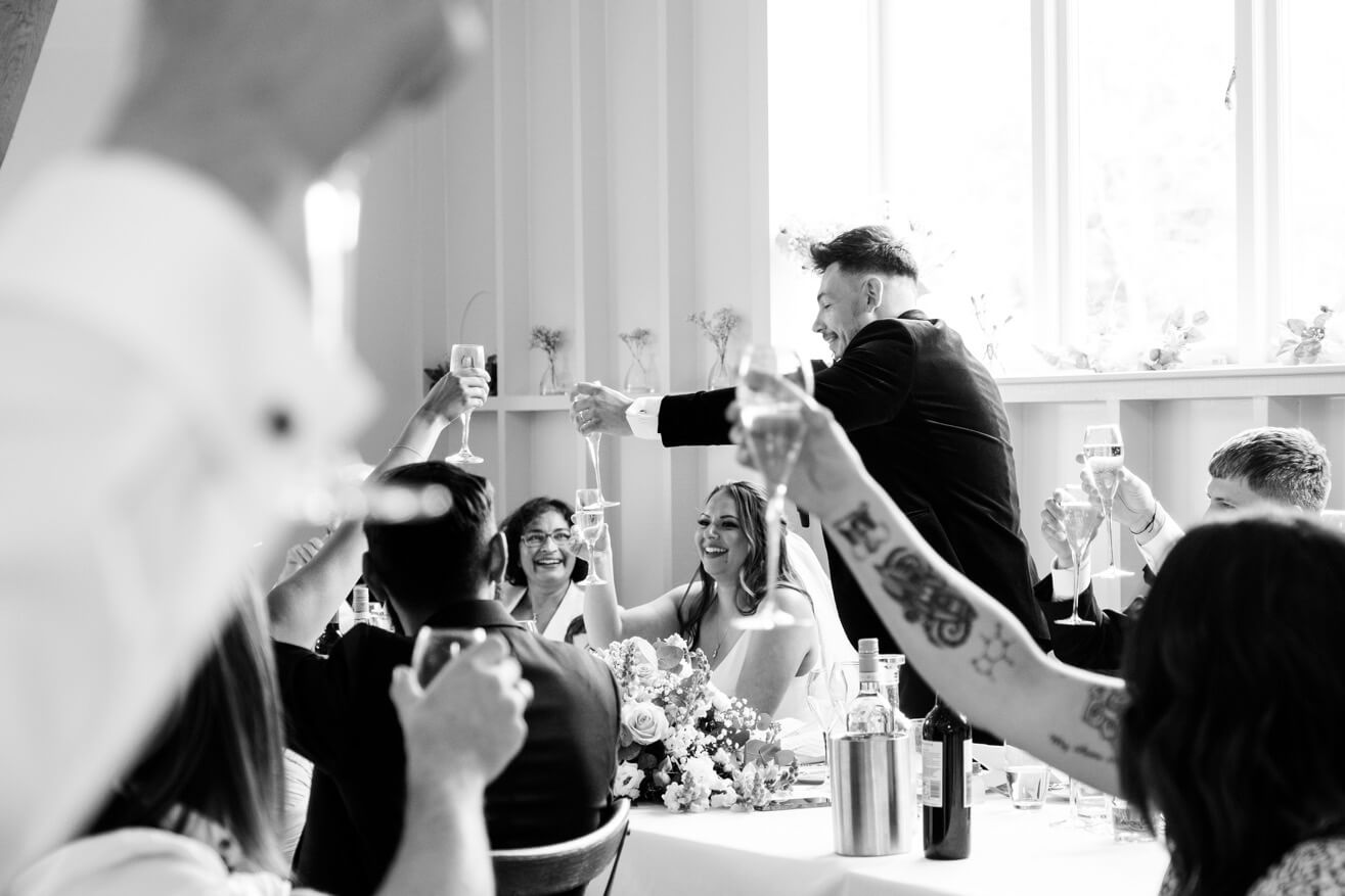 Groom raising a toast at Hyde House