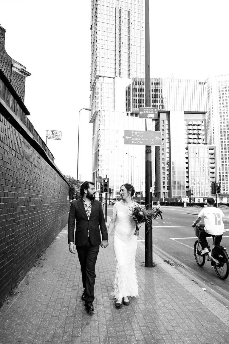 Bride and groom walking a London street, city micro wedding