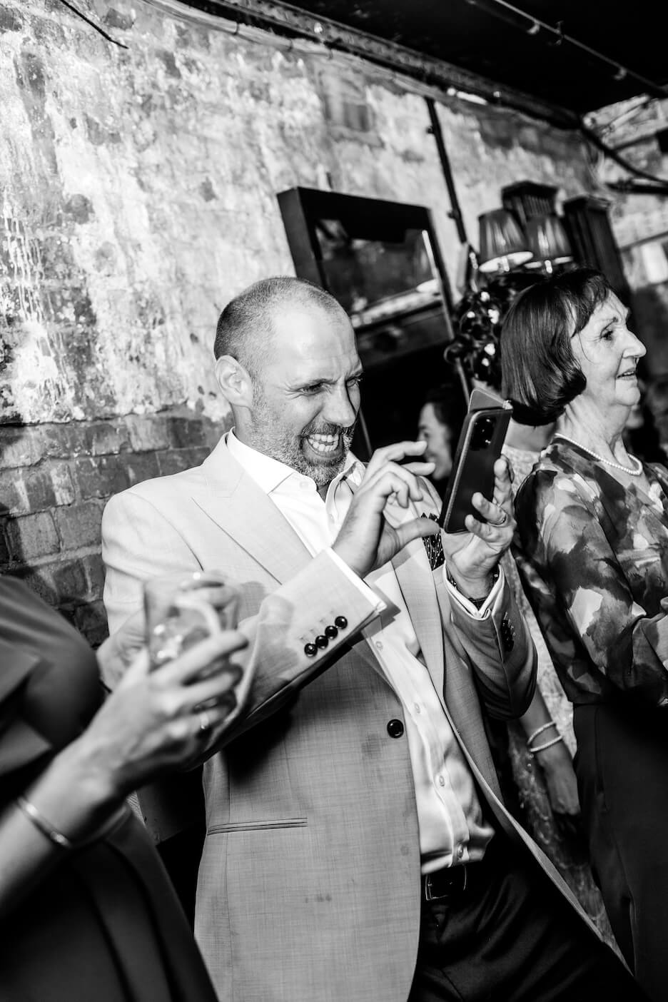 A guest laughing on the dance floor, London micro wedding
