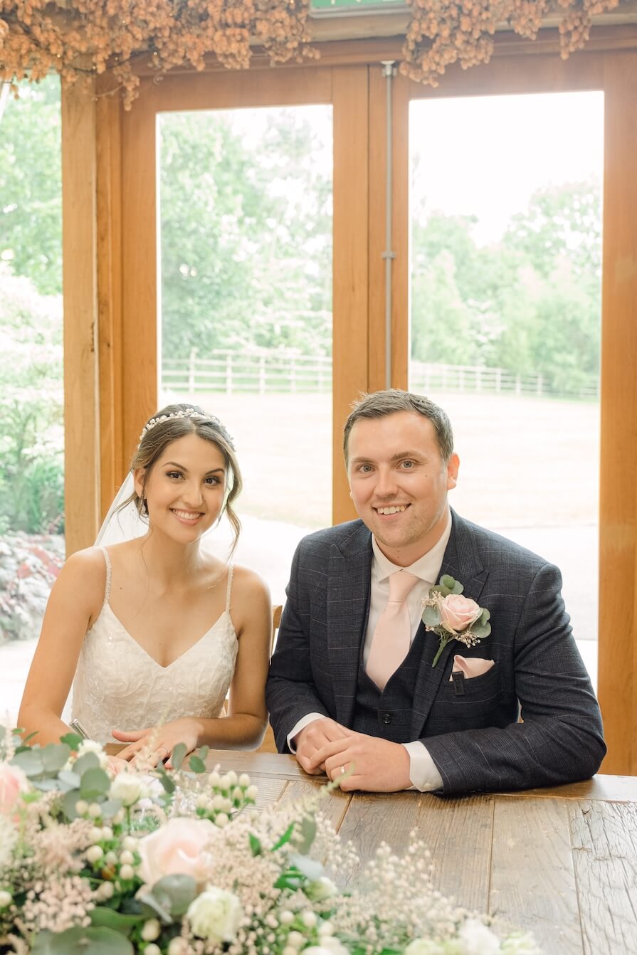 Signing the register at a Mythe Barn wedding