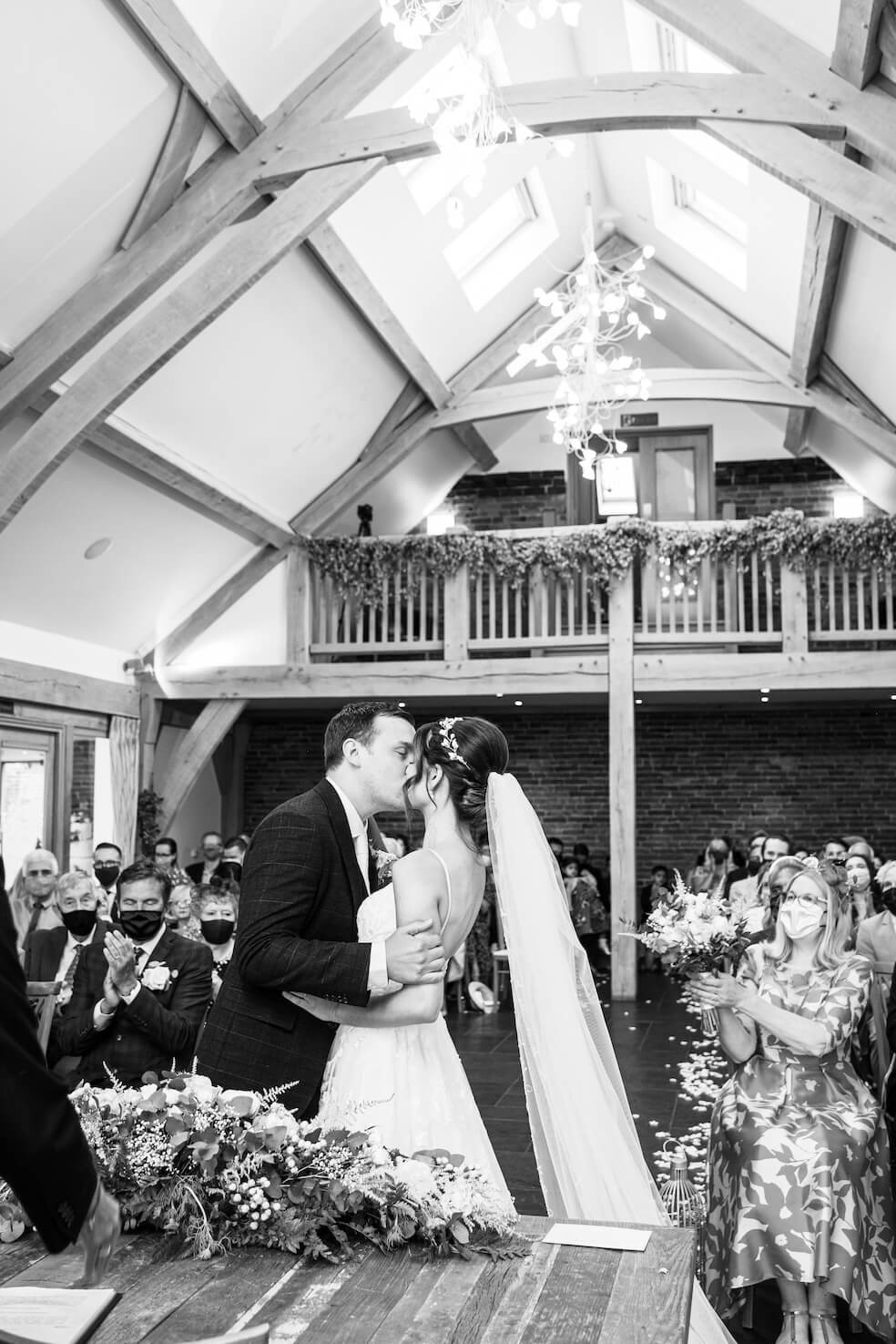 Black and white first kiss at a Mythe Barn wedding