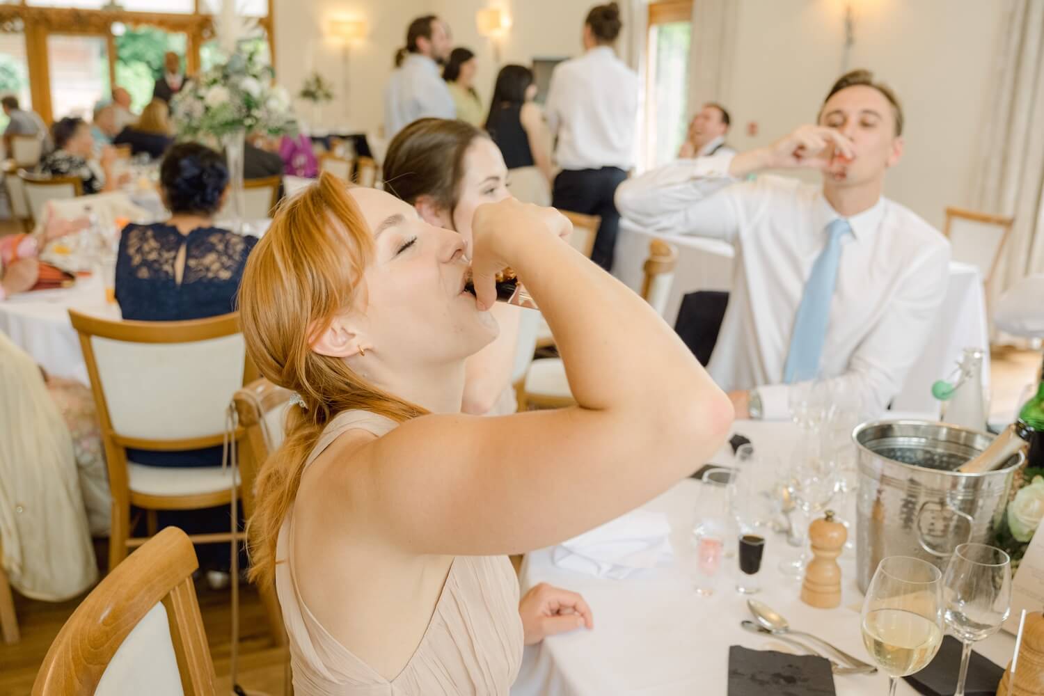 Wedding guests enjoying drinks at Mythe Barn
