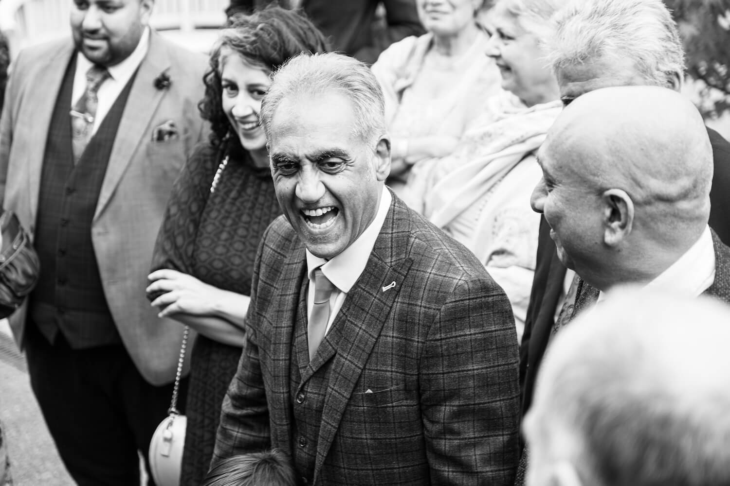 Father of the bride watching the magician at Mythe Barn