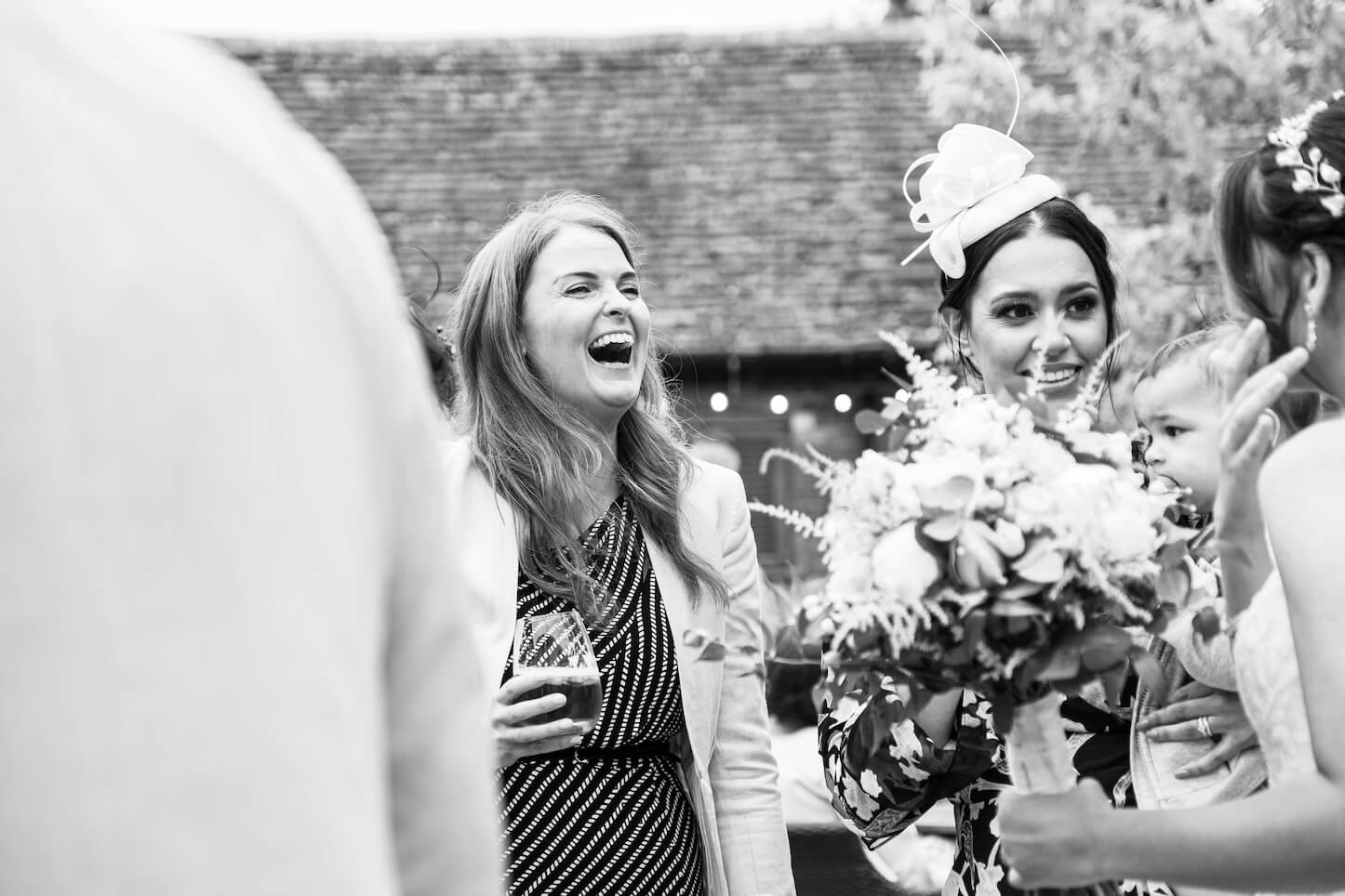 Wedding guests watching close-up magic at Mythe Barn