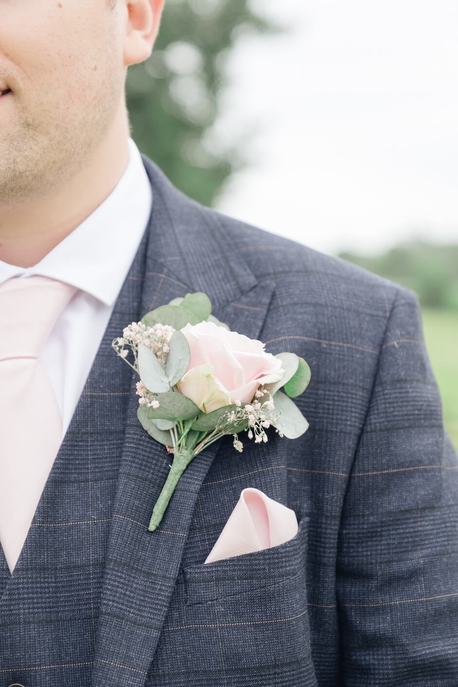 Groom buttonhole detail at Mythe Barn