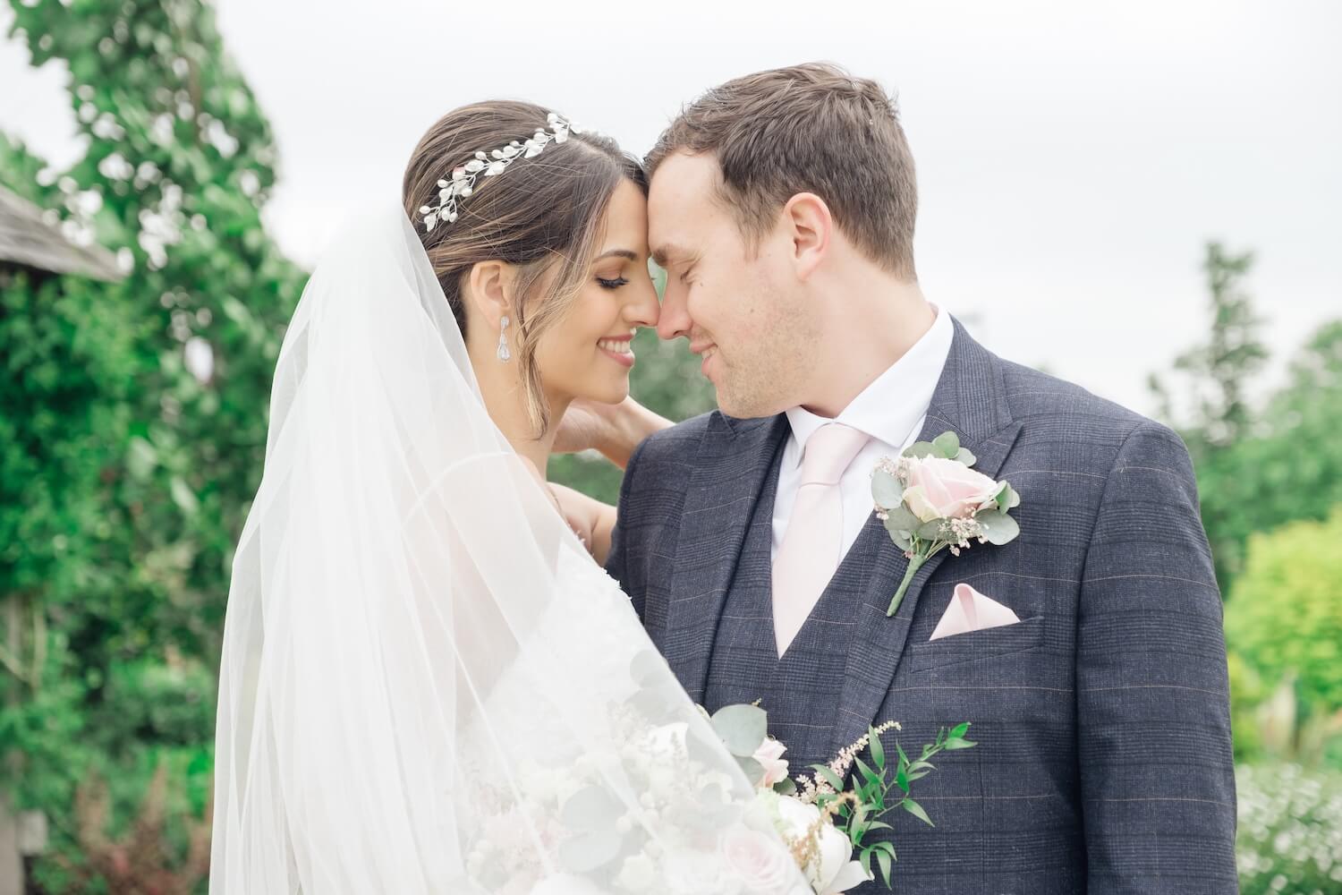 Bride and groom portrait in the grounds at Mythe Barn
