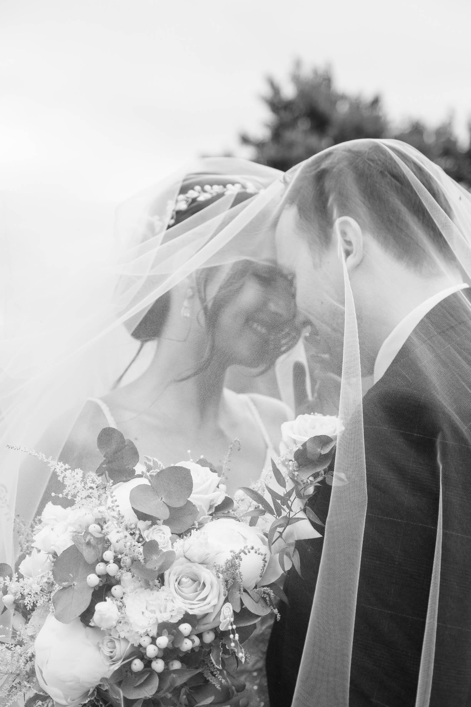 Black and white Mythe Barn wedding photography of a bride and groom