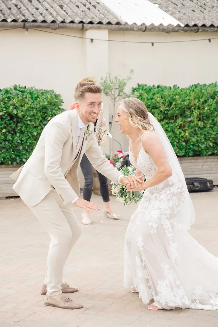 Bride and groom dancing in the courtyard at Stratton Court Barn