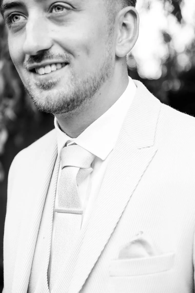 Black and white portrait of the groom at Stratton Court Barn