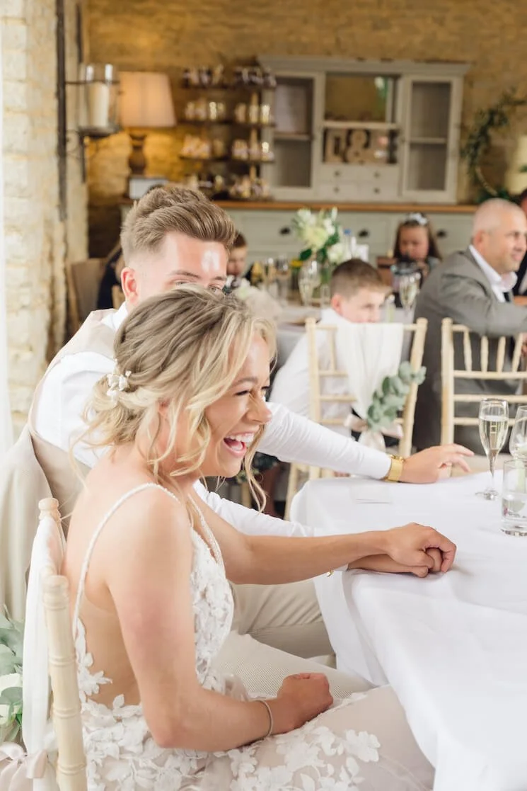 Laughing bride during speeches at Stratton Court Barn