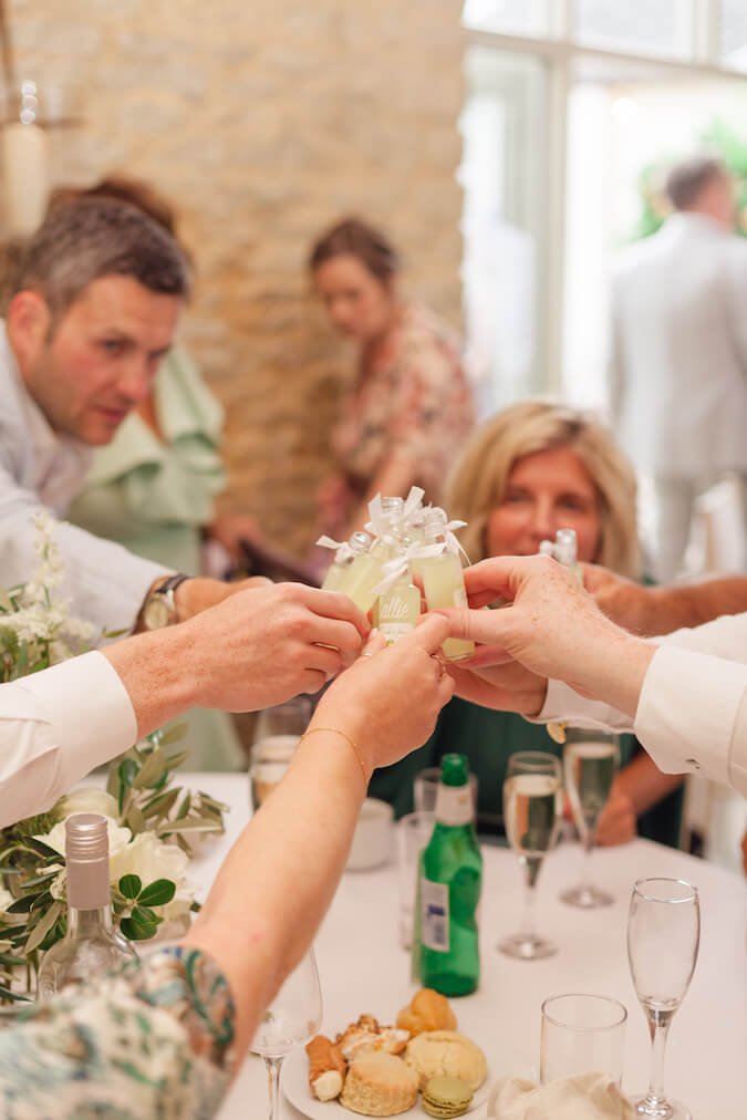 Guests clinking shots at a Stratton Court Barn wedding