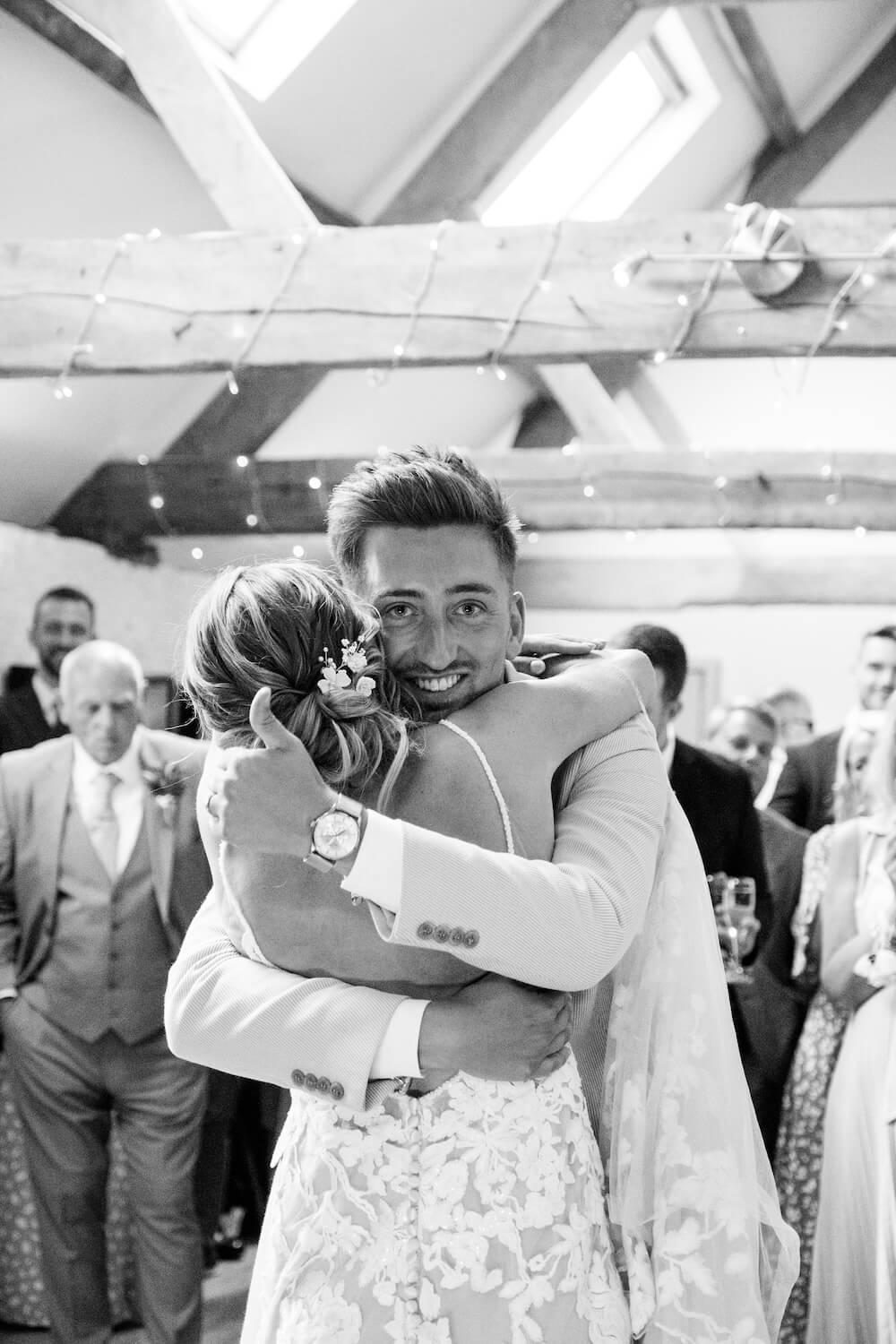 Groom hugging the bride during their first dance at Stratton Court Barn