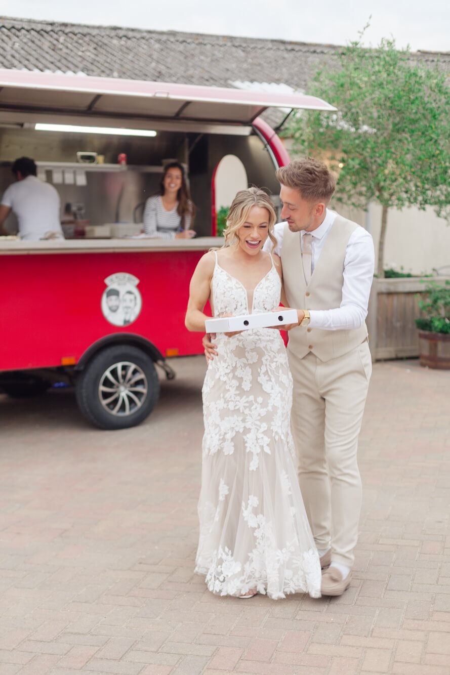 Bride and groom with pizza at Stratton Court Barn