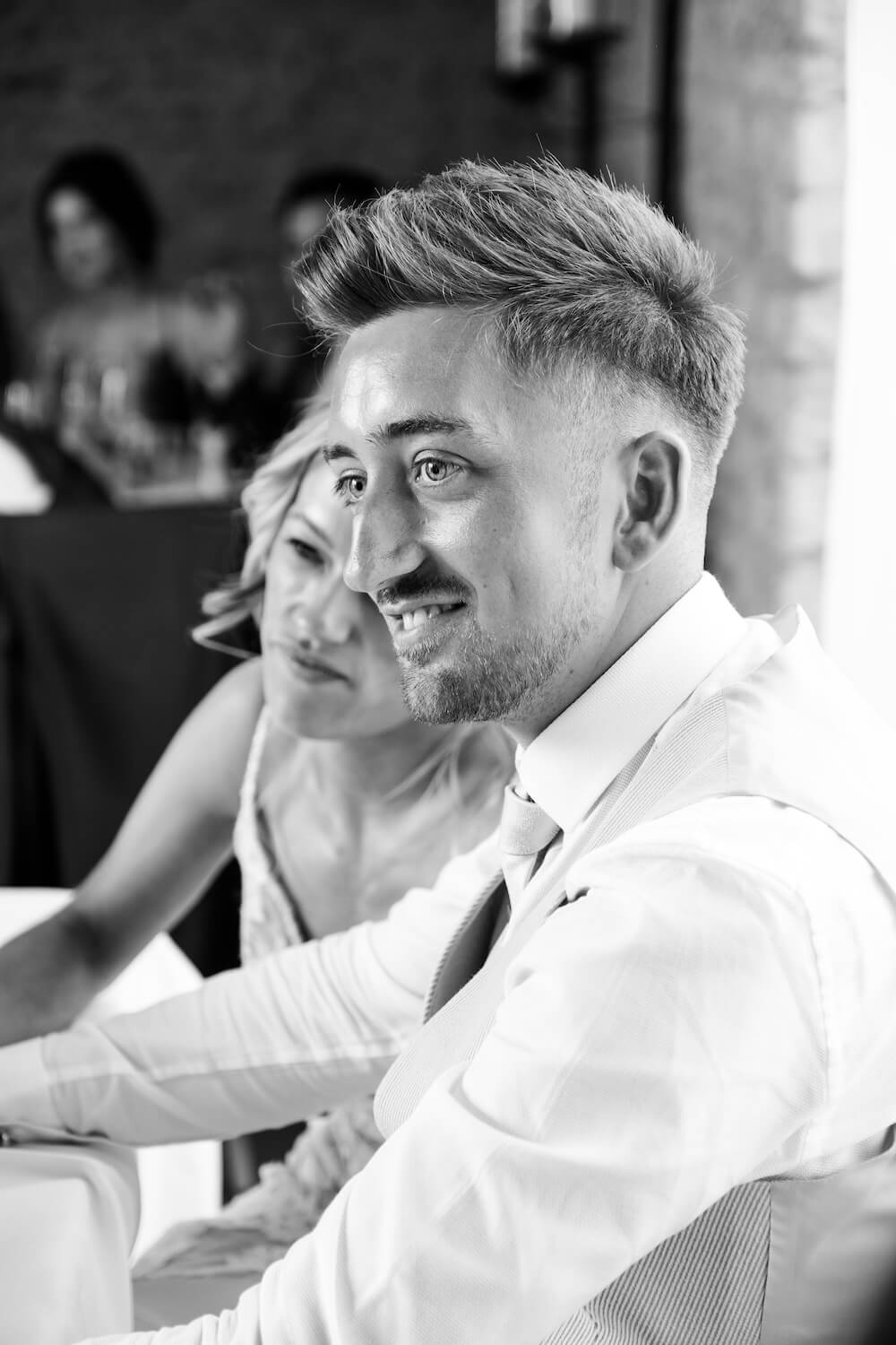 Black and white of the groom during his speech at Stratton Court Barn