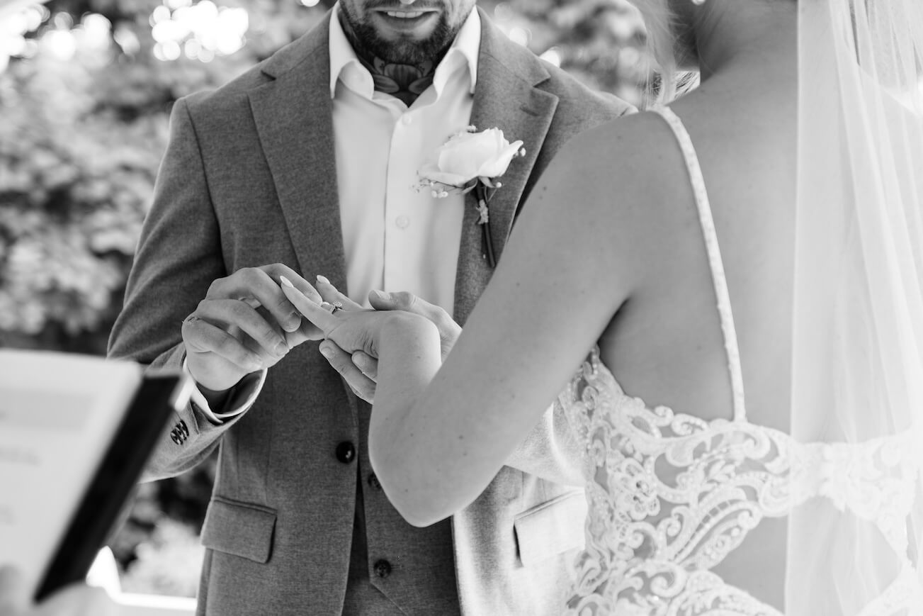Exchanging rings during the ceremony at Warwick House
