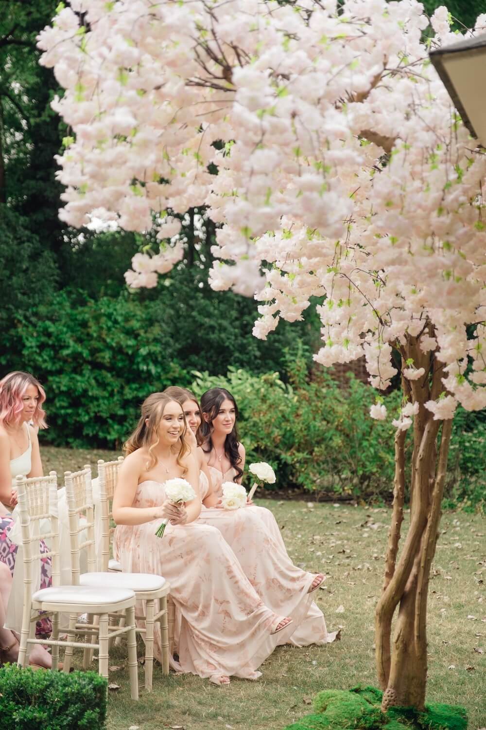 Bridesmaids by the cherry blossom at Warwick House