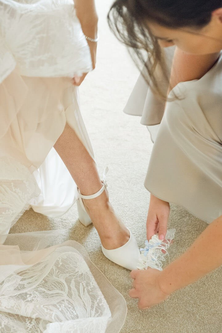 Garter going on during bridal preparations