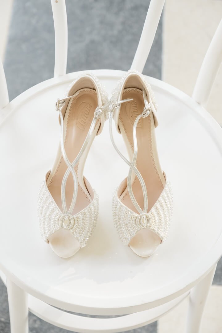 Bridal shoes waiting on a stool in the bridal suite