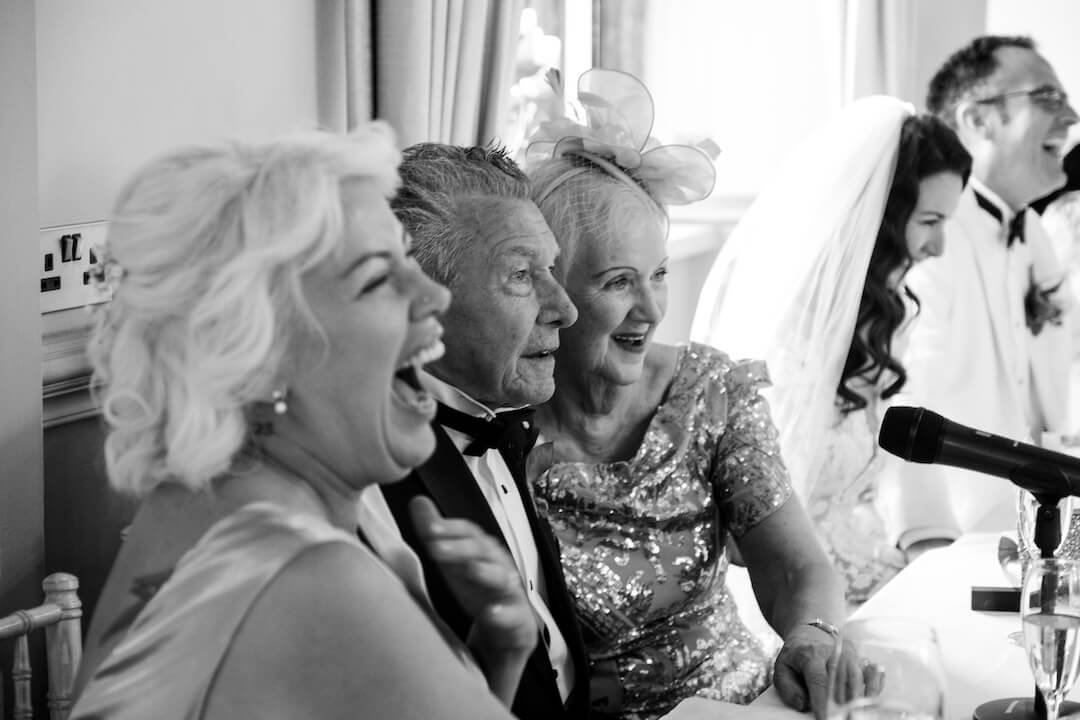Guests laughing during the speeches at Weston Hall