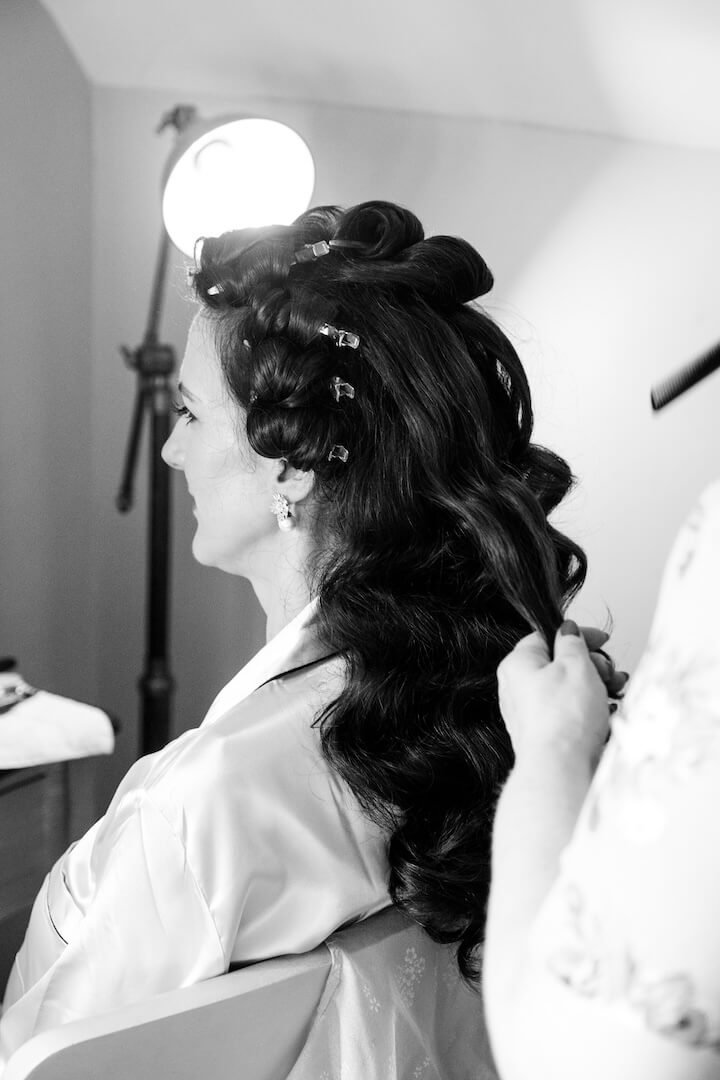 Bride having her hair styled in the honeymoon suite at Weston Hall