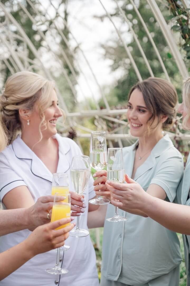 Bridesmaids toasting with champagne during getting ready