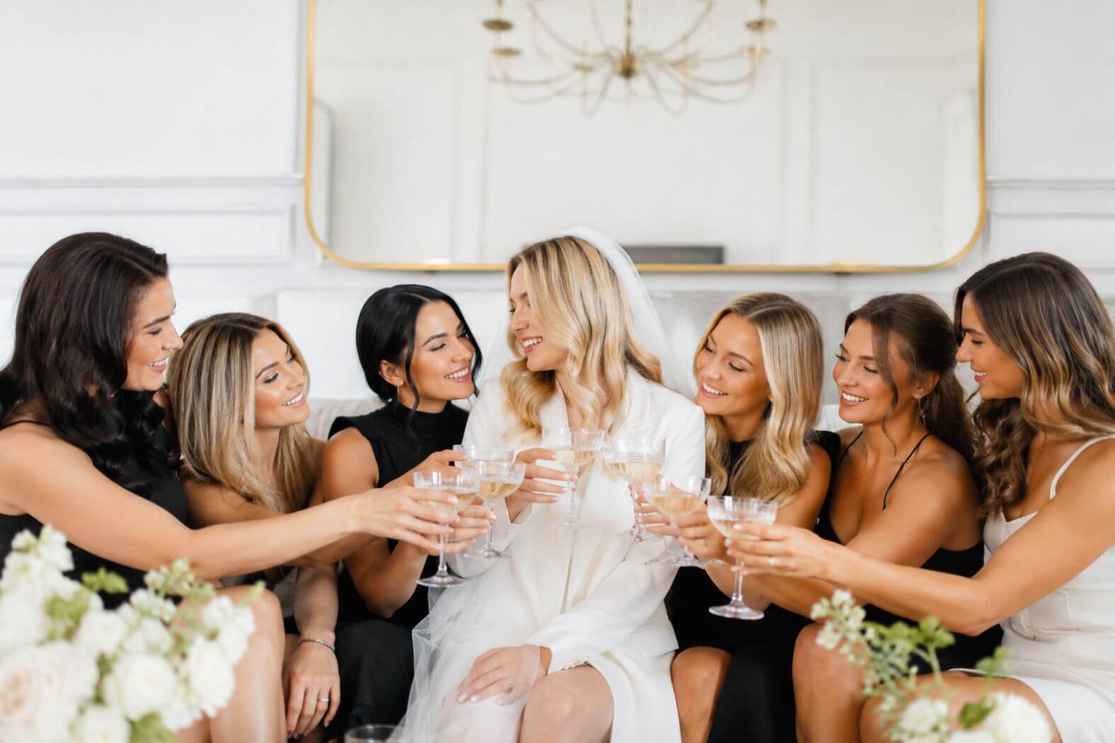 Hens raising a toast with fizz during a hen party drinking game