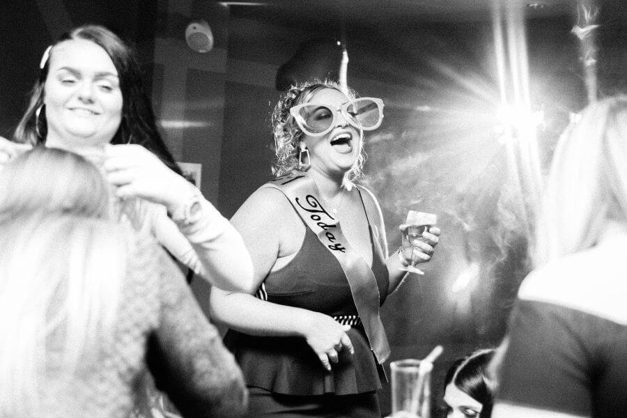 Group of women celebrating with fizz at a classy hen party
