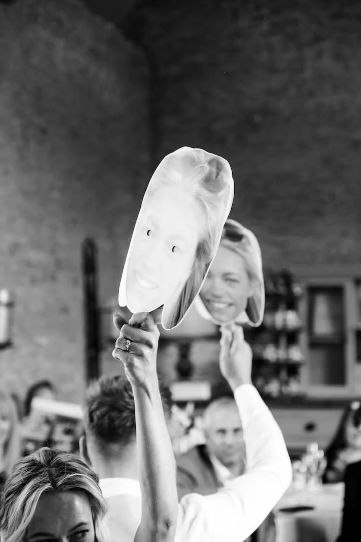 Couple laughing at a cheeky question during the Mr and Mrs wedding game